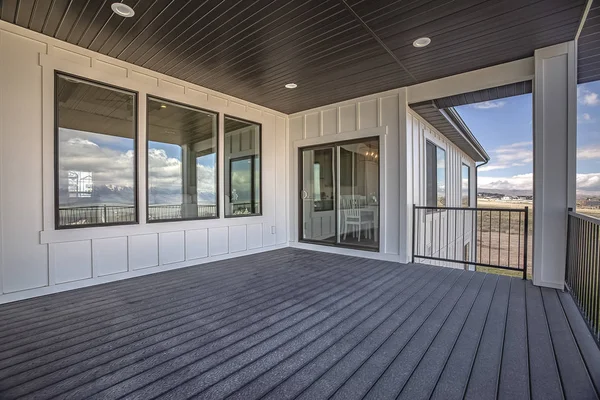 Spacious balcony of home with white wall and round lights on the brown ceiling — Stock Photo, Image