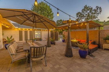 Bir evin rahat taş veranda üzerinde açık yemek ve oturma alanı