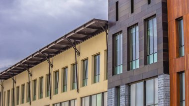 Kabarık gri bulutlar ile kaplı gökyüzüne karşı düz bir çatı ile Panorama çerçeve Bina dış