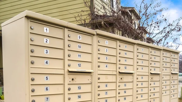 Panorama frame Residential mailboxes with numbered compartments on the side of a road