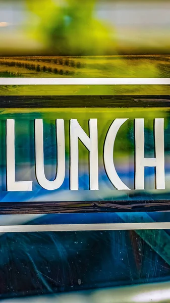 Vista vertical Close-up de um sinal de almoço contra a parede de vidro de um restaurante — Fotografia de Stock