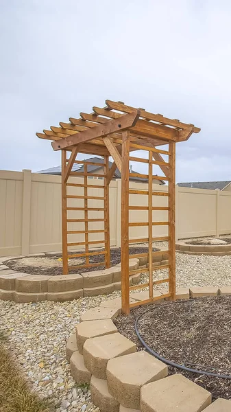 Vertical frame Heart shaped planting beds and wooden arbor at the yard of a home