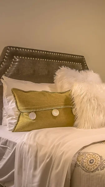 Vertical frame Double bed with fluffy pillows against the upholstered belgrave headboard