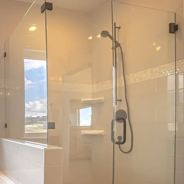 Square frame Built in square bathtub inside a bathroom with white wall and sliding window