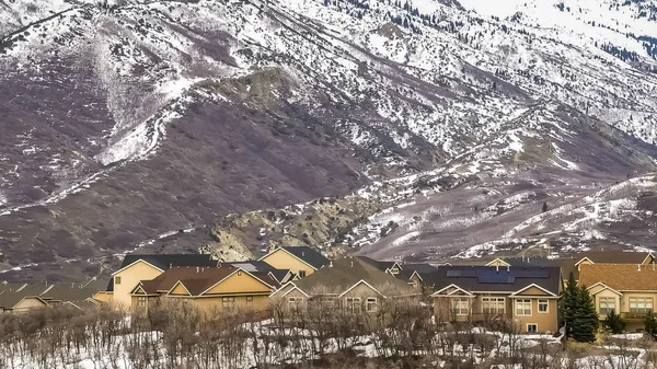 Marco panorámico Área residencial en la base de una imponente montaña nevada contra el cielo nublado — Foto de Stock