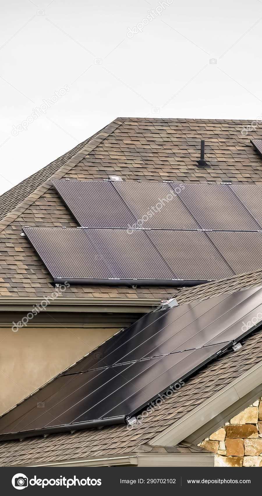 Vertical Solar Panels On The Dark Pitched Roof Of A Home With Stone And Concrete Wall Stock Photo Image By C Dropthepress Gmail Com 290702102