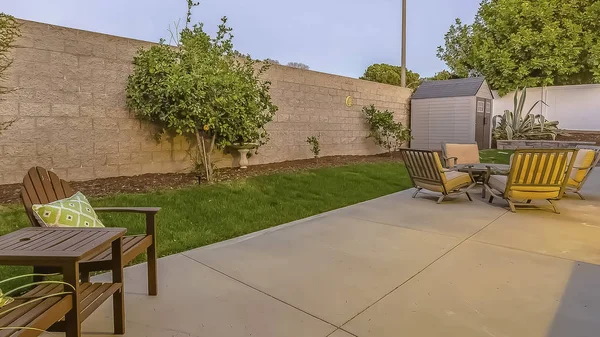 Panorama frame Spacious patio at the backyard of a home with a seating and dining area