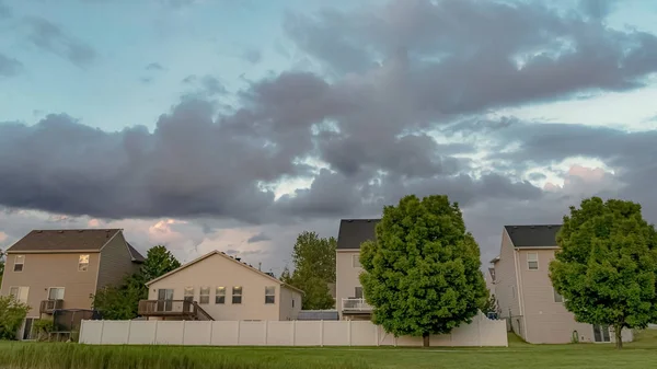 Panorama Barrio escénico con casas encantadoras y exuberantes árboles verdes bajo un cielo nublado — Foto de Stock