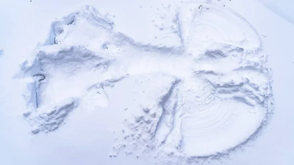 frame Winter scenery with close up on a snow angel made on fresh powdery snow