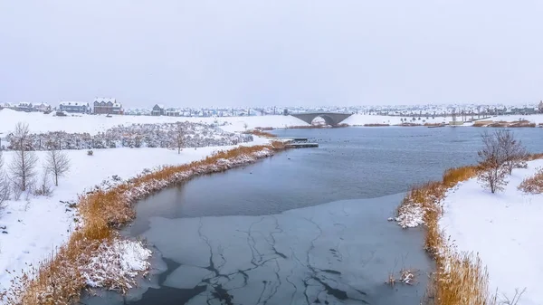 Panorama Secnery naturaleza helada con un lago rodeado de terreno nevado en invierno — Foto de Stock