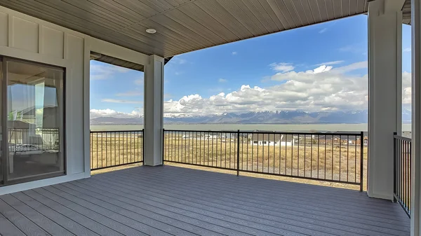 Panorama frame Balcony with view of cloudy blue sky over homes lake and snow capped mountain