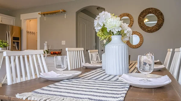 Panorama frame Dining room interior with brown wooden table and white wooden chairs