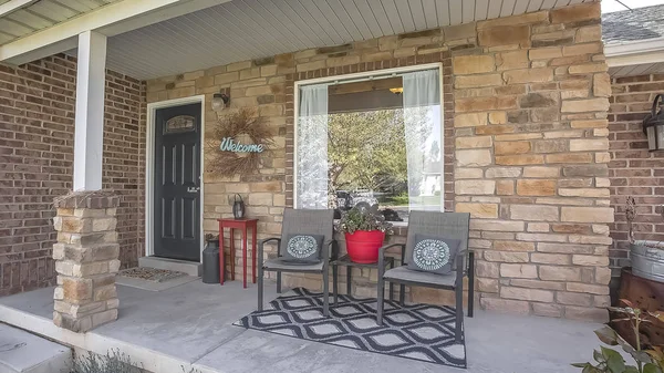 Panorama frame Furniture and Welcome wreath on the porch of home with red brick exterior wall — Stock Photo, Image