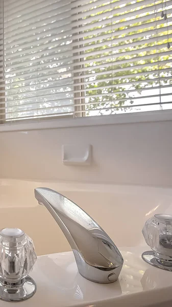 Bañera pulida vertical con grifo brillante y mango de cristal doble dentro de un baño — Foto de Stock