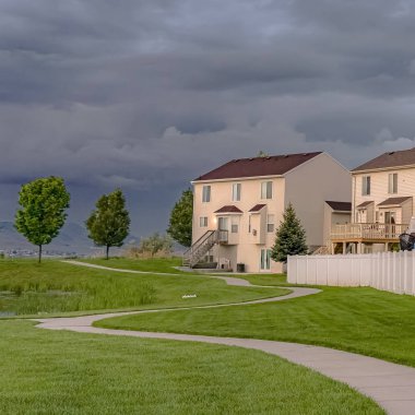 Kare Ev cephe asfalt bir yol ve gölet ile geniş bir yeşil alana bakan