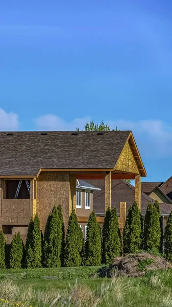 Vertical Exterior of house under construction with blue sky background on a sunny day