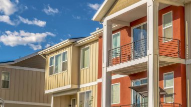 Turuncu ve beyaz dış duvar bölümleri ile çok katlı evlerin Panorama çerçeve Cephe