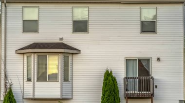 Beyaz duvar cumbalı pencere küçük balkon ve ahşap çit ile evin Panorama Cephe