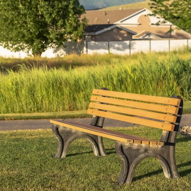 Kare çerçeve Güneşli bir günde çimenli arazi üzerinde gölge döküm Boş açık park tezgah