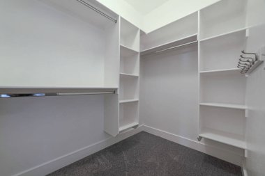 Raflar metal çubuklar ve kancalar ile yeni bir evin dolaba boş yürüyüş