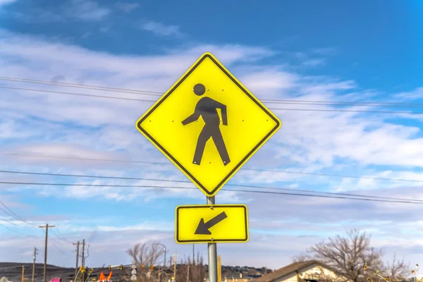 Yellow Pedestrian Crossing and Arrow sign with cloudy blue sky in the background — Stock Photo, Image