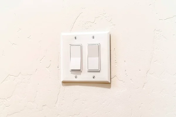 Indoor multiple rocker light switch with broad flat levers and cover plate