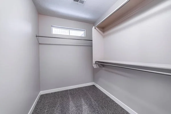 Colgar varillas de ropa de metal en el interior del armario vacío interior de un nuevo hogar — Foto de Stock