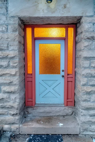 Frosted glass panes on the front door sidelights and transom window of home