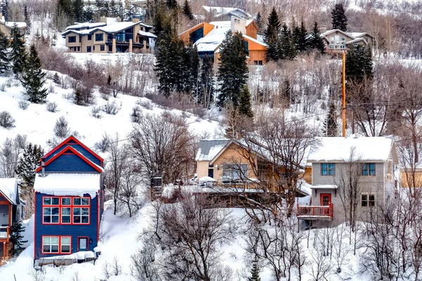 Casas coloridas en la pendiente de la colina con vista al terreno nevado y la belleza natural — Foto de Stock