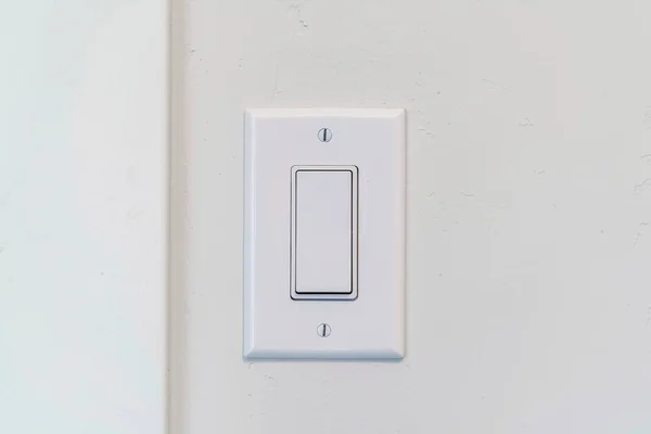 Electrical rocker light switch with flat broad lever on white interior wall — Stock Photo, Image