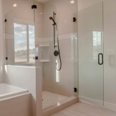 Square frame Built in bathtub with black faucet and shower stall with half glass enclosure clipart