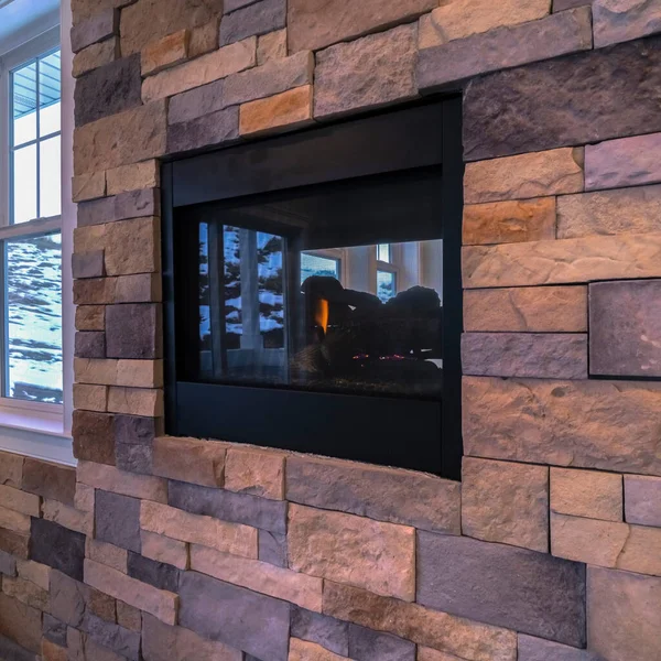 Square Fireplace mounted inside decorative wall interior brick