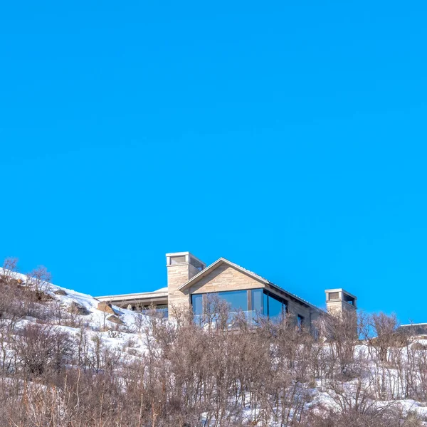 Square Park City Utah mountain scenery in winter with homes against blue sky background