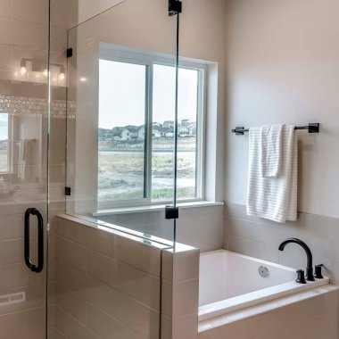Square Frameless walk in shower stall and built in bathtub inside tile wall bathroom clipart