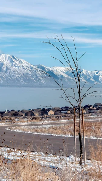 Pystysuora runko Tie ja kodit ovelooking luminen Wasatch vuoret ja sininen Utah järvi talvella — kuvapankkivalokuva