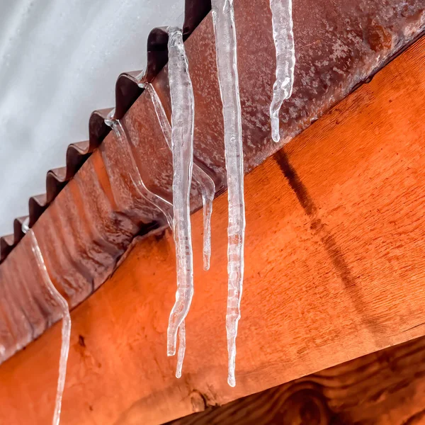 Marco cuadrado Icicles en el borde del techo de metal corrugado con montículo de nieve fresca en invierno — Foto de Stock