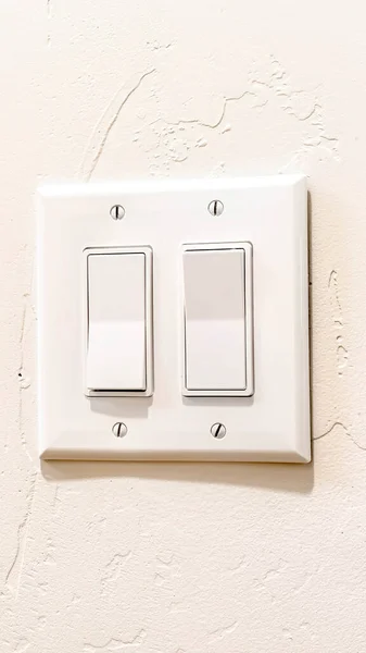 Vertical crop Indoor multiple rocker light switch with broad flat levers and cover plate — Stock Photo, Image