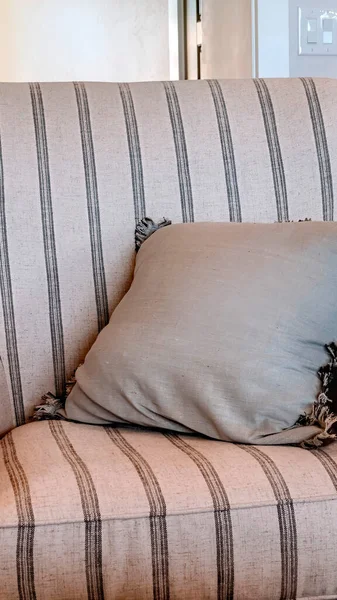 Vertical Striped armchair with fringed throw pillow inside living room with wooden floor — Stock Photo, Image