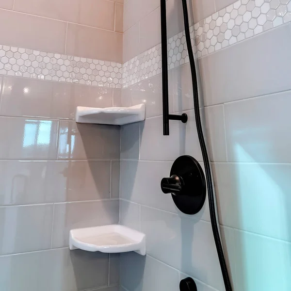 Square frame Black round shower head and handle inside the walk in bathroom shower stall