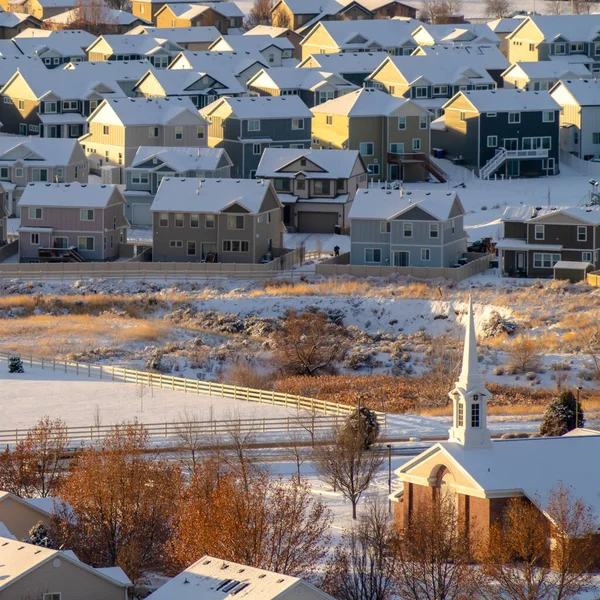 Square frame Homes and church in snow covered Utah Valley neighborhood in winter