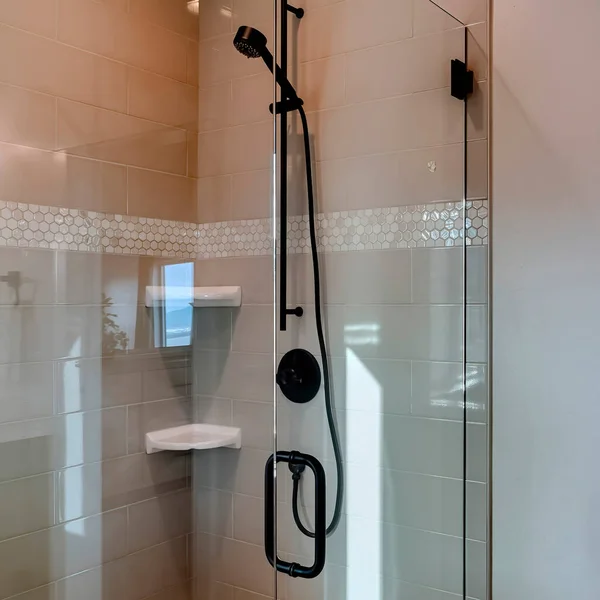 Square Shower stall with frameless glass enclosure and hinged door inside bathroom