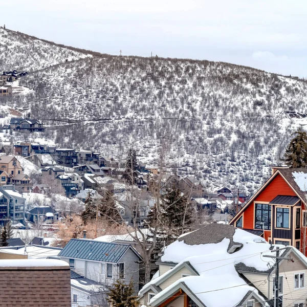 Square Park City Utah mountain in winter with colorful homes that sit on snowy slopes