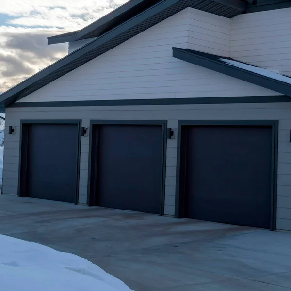 Square crop Garage entrance of a home on the scenic snowy terrain of Wasatch Mountains
