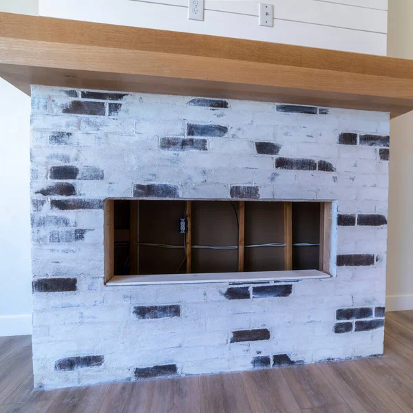 Square Decorative fireplace in empty living room interior