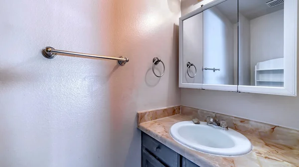 Panorama Oval sink on marble countertop with cabinet inside bathroom of home