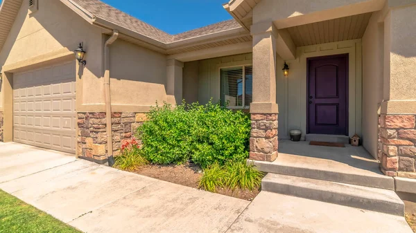 Panorama frame Facade of home with gable roofs over the entrance and garage against blue sky — Stock Photo, Image