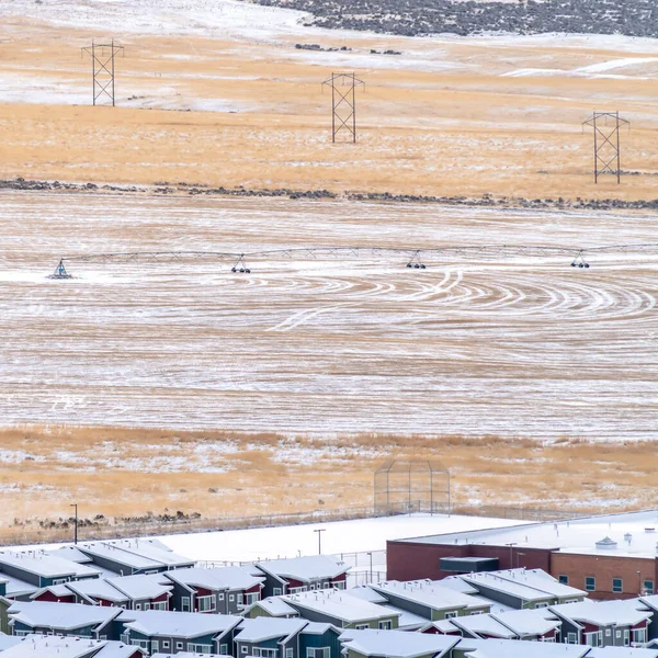 Square Homes and agricultural land with irrigation in snowy Utah Valley during winter