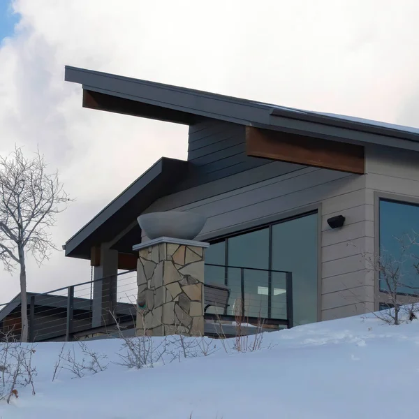 Square crop Modern home on the snow covered terrain of wasatch Mountains viewed in winter