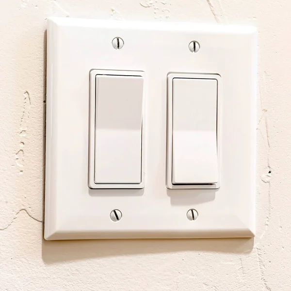 Square crop Indoor multiple rocker light switch with broad flat levers and cover plate — Stock Photo, Image