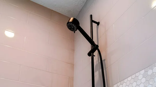 Panorama frame Black round shower head and handle inside the walk in bathroom shower stall